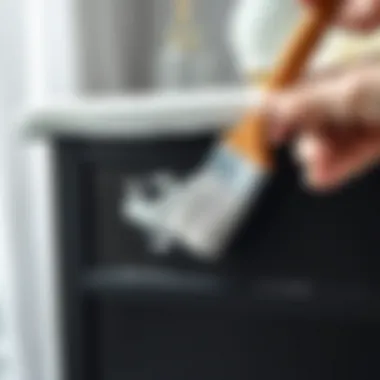 Brush applying white paint to dark furniture