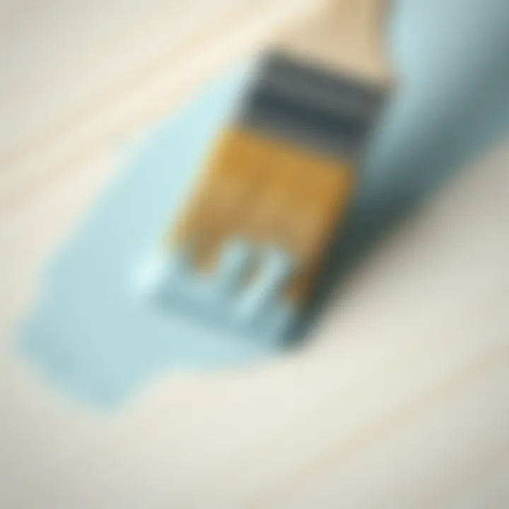 A close-up of a brush applying paint on a smooth MDF surface.