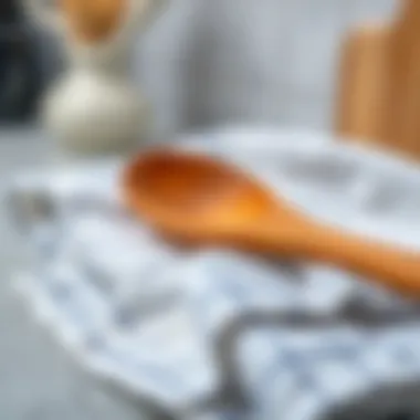 A wooden spoon resting on a clean kitchen towel, symbolizing care